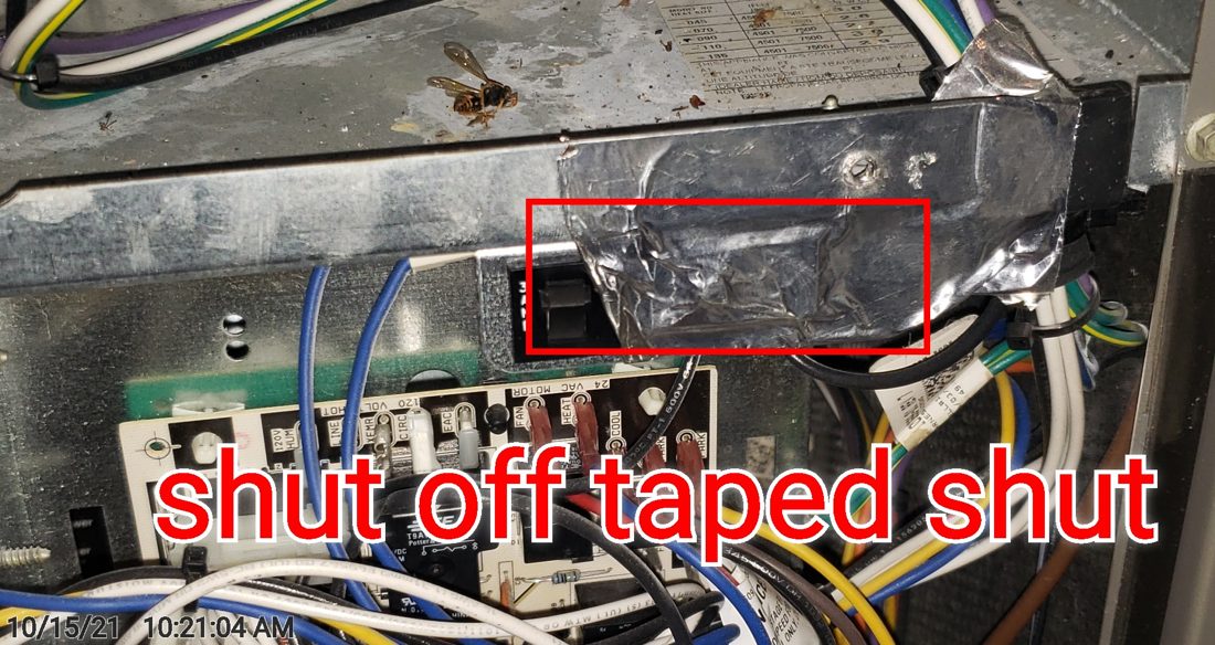 A furnace blower-door safety switch taped over and disabled