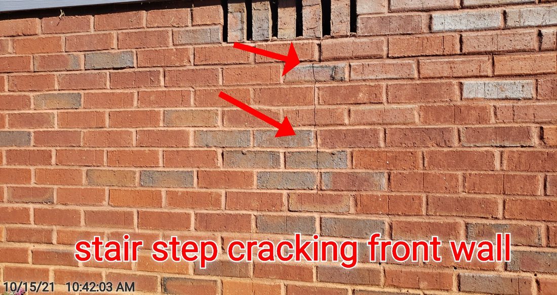Stair-step cracking stepping through a brick foundation wall